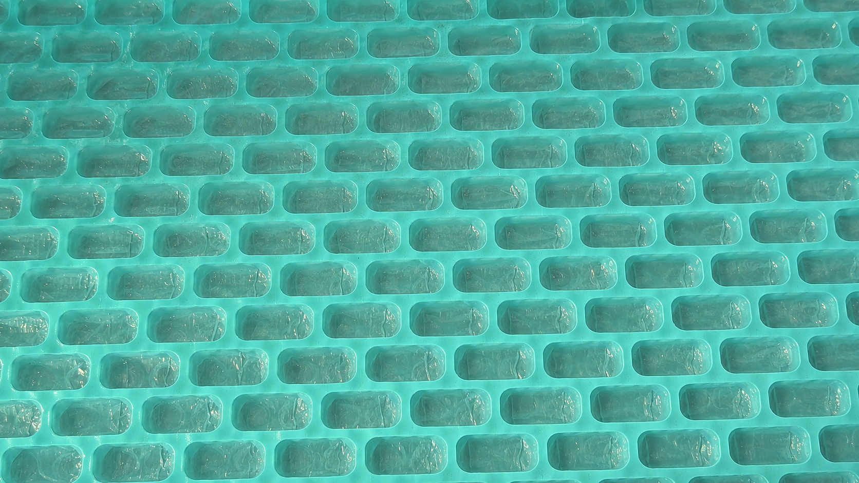 Close-up of turquoise Thermoloc insulation material structure